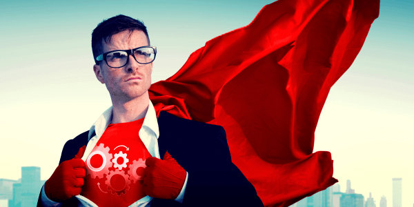 A man in business attire with a red cape flowing behind him, opening his shirt to reveal a superhero costume with gear symbols, against a city skyline backdrop, symbolizing empowerment and innovation in a corporate context.